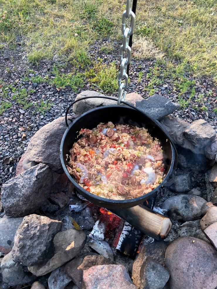 Jambalaya cooking over a campfire
